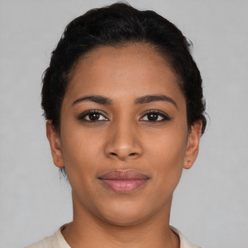 Joyful latino young-adult female with short  black hair and brown eyes