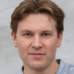 Joyful white adult male with short  brown hair and grey eyes