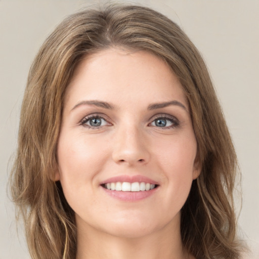 Joyful white young-adult female with medium  brown hair and green eyes