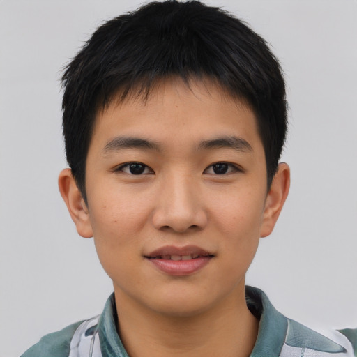 Joyful asian young-adult male with short  brown hair and brown eyes