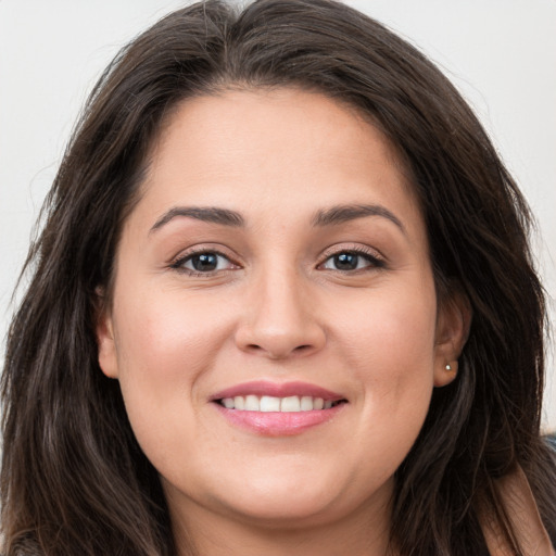 Joyful white young-adult female with long  brown hair and brown eyes