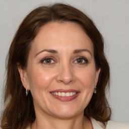 Joyful white adult female with medium  brown hair and grey eyes