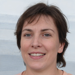 Joyful white adult female with medium  brown hair and brown eyes