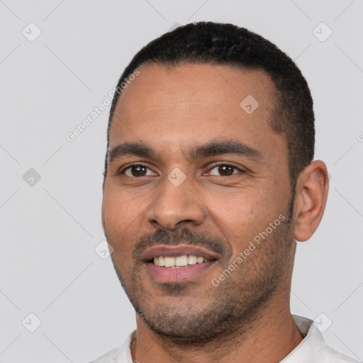 Joyful white young-adult male with short  black hair and brown eyes