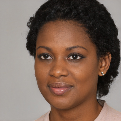 Joyful black young-adult female with medium  black hair and brown eyes
