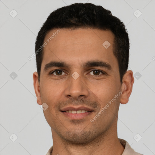 Joyful white young-adult male with short  black hair and brown eyes