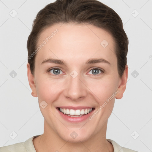 Joyful white young-adult female with short  brown hair and grey eyes