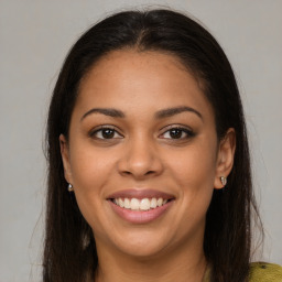 Joyful latino young-adult female with long  brown hair and brown eyes