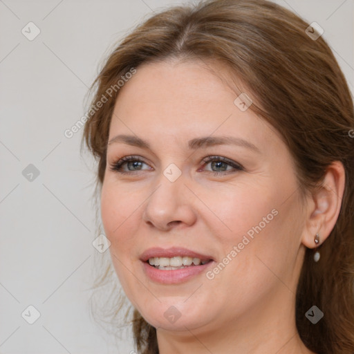 Joyful white adult female with medium  brown hair and grey eyes