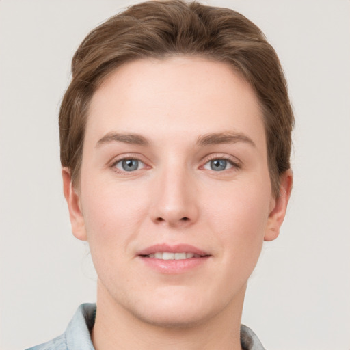 Joyful white young-adult female with short  brown hair and grey eyes