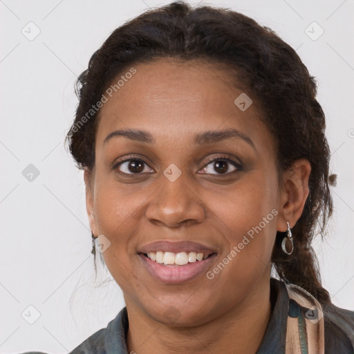 Joyful black adult female with medium  brown hair and brown eyes