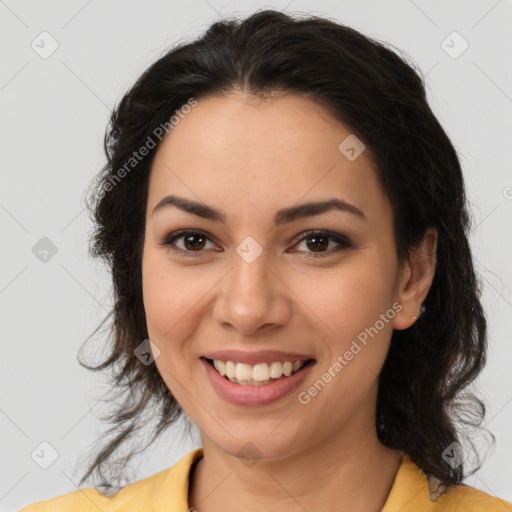 Joyful latino young-adult female with medium  brown hair and brown eyes