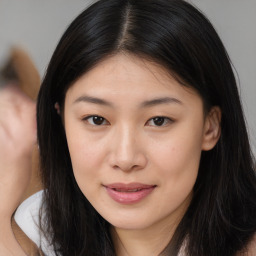 Joyful asian young-adult female with long  brown hair and brown eyes