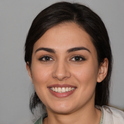 Joyful white young-adult female with medium  brown hair and brown eyes