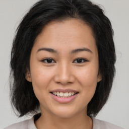 Joyful asian young-adult female with medium  brown hair and brown eyes