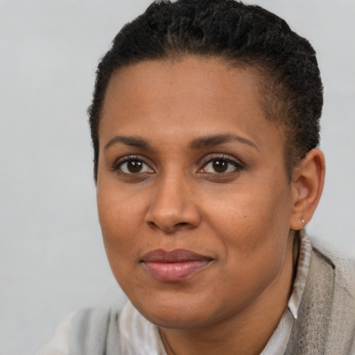 Joyful black young-adult female with short  brown hair and brown eyes