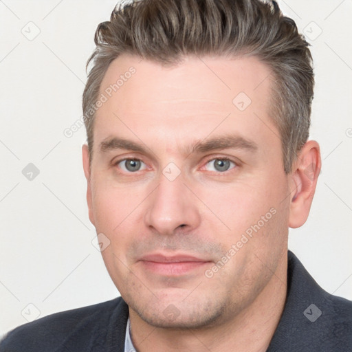 Joyful white adult male with short  brown hair and grey eyes