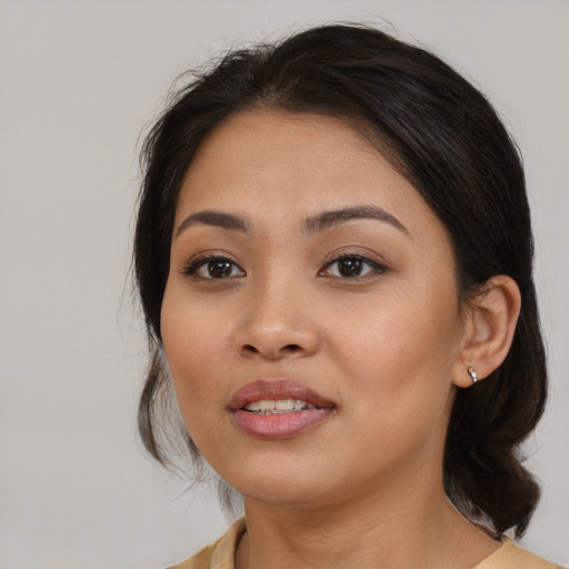 Joyful asian young-adult female with medium  black hair and brown eyes