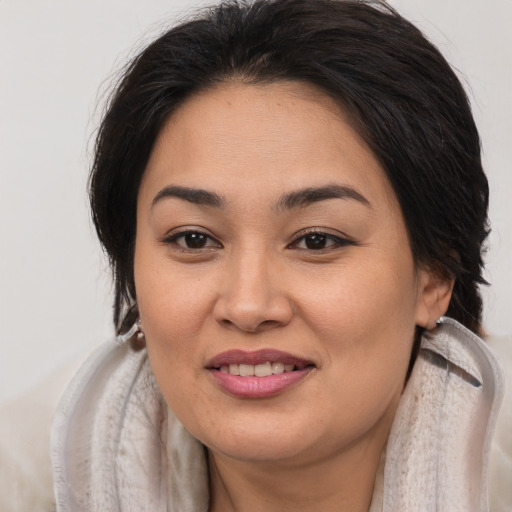 Joyful asian young-adult female with long  brown hair and brown eyes