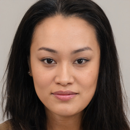 Joyful asian young-adult female with long  brown hair and brown eyes