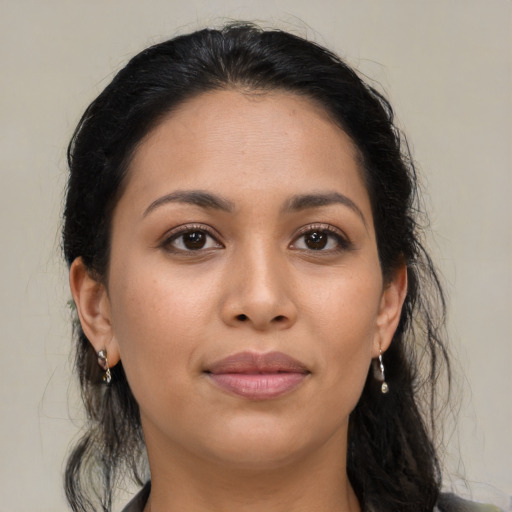 Joyful latino young-adult female with long  brown hair and brown eyes