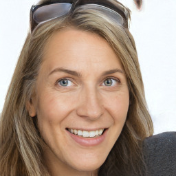 Joyful white adult female with long  brown hair and grey eyes