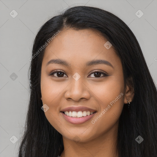 Joyful latino young-adult female with long  black hair and brown eyes