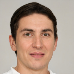 Joyful white adult male with short  brown hair and brown eyes