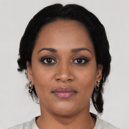 Joyful black young-adult female with medium  black hair and brown eyes