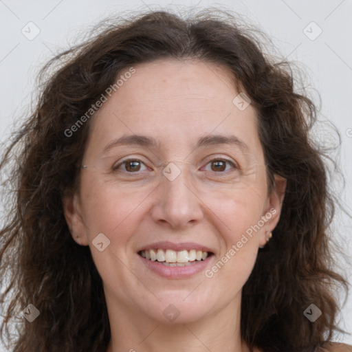 Joyful white adult female with long  brown hair and brown eyes