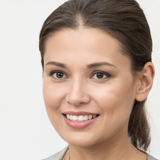 Joyful white young-adult female with medium  brown hair and brown eyes