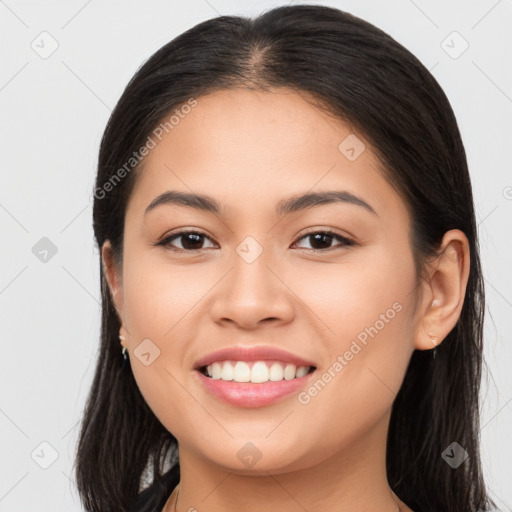 Joyful latino young-adult female with long  brown hair and brown eyes