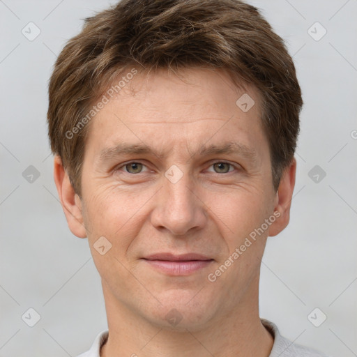 Joyful white adult male with short  brown hair and grey eyes