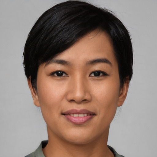 Joyful asian young-adult female with short  black hair and brown eyes