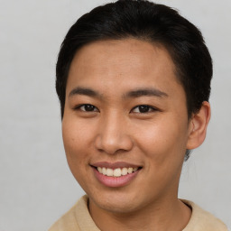 Joyful asian young-adult male with short  brown hair and brown eyes