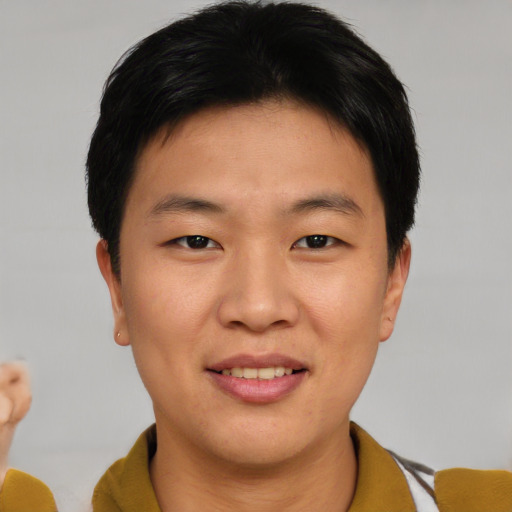 Joyful asian young-adult male with short  brown hair and brown eyes