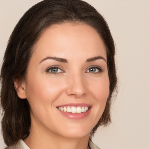 Joyful white young-adult female with medium  brown hair and brown eyes