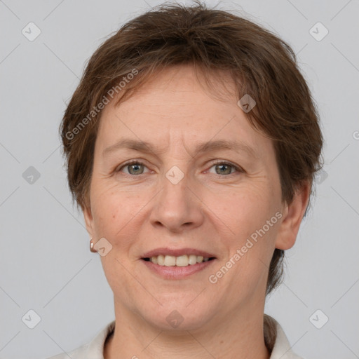 Joyful white adult female with short  brown hair and grey eyes