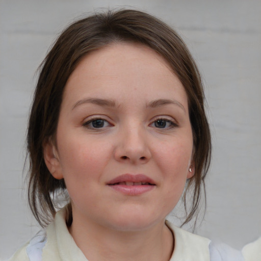 Joyful white child female with medium  brown hair and blue eyes