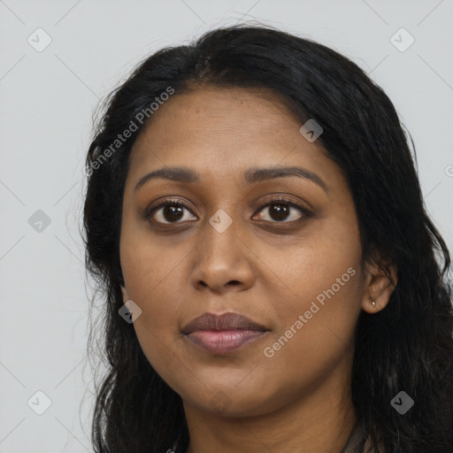 Joyful black young-adult female with long  black hair and brown eyes