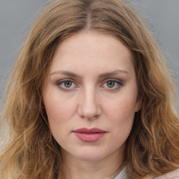 Joyful white young-adult female with long  brown hair and green eyes