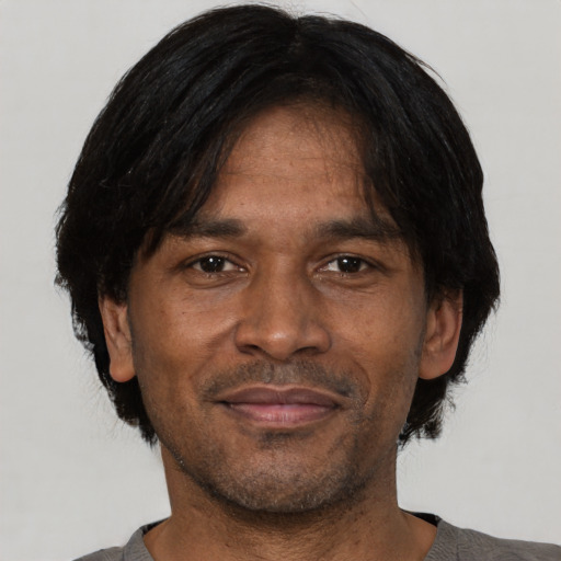 Joyful black adult male with short  black hair and brown eyes