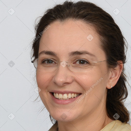 Joyful white adult female with medium  brown hair and brown eyes