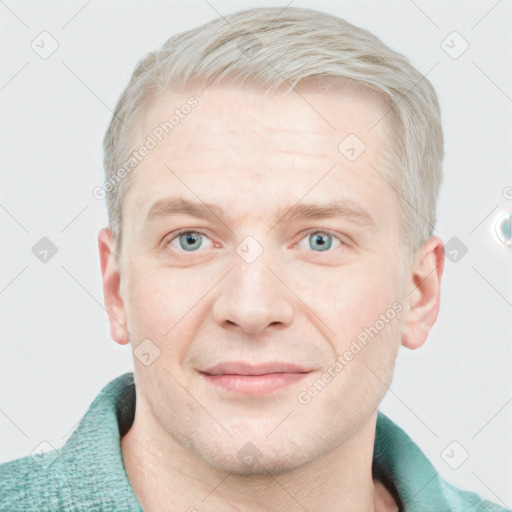 Joyful white young-adult male with short  brown hair and blue eyes