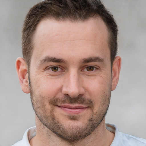 Joyful white adult male with short  brown hair and brown eyes