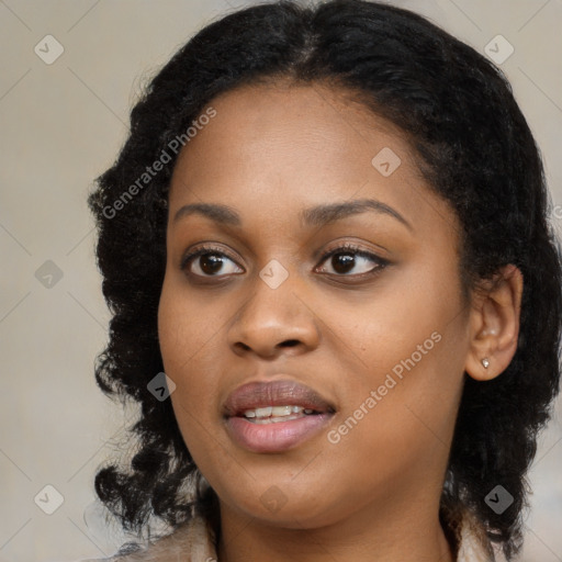 Joyful black young-adult female with long  black hair and brown eyes