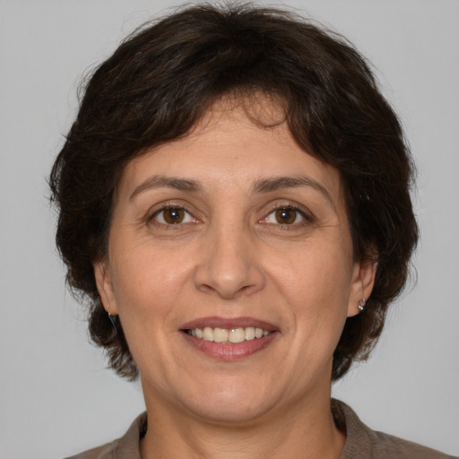 Joyful white adult female with medium  brown hair and brown eyes