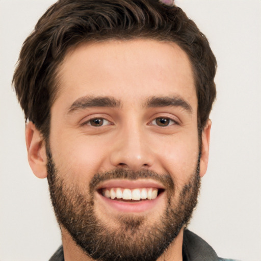 Joyful white young-adult male with short  black hair and brown eyes