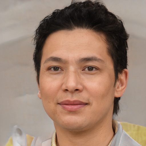 Joyful asian adult male with short  brown hair and brown eyes
