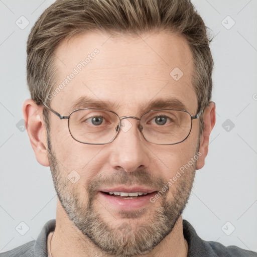 Joyful white adult male with short  brown hair and grey eyes